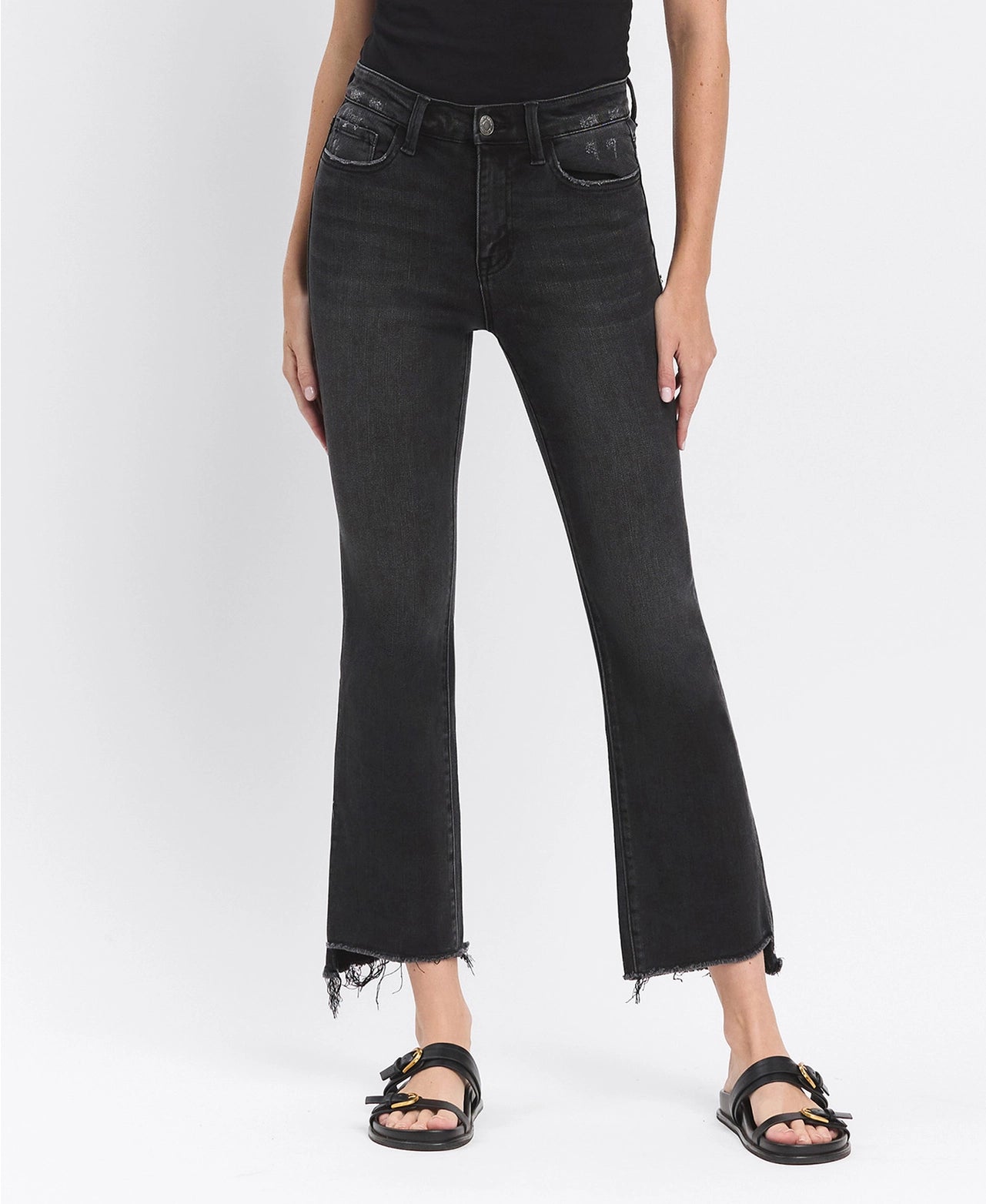 Person wearing black jeans on a white background