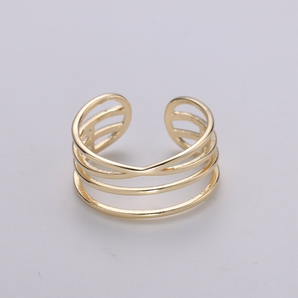 Gold open ring on a light gray background