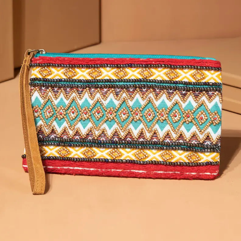 Handmade fine cotton yarn dyed jacquard fabric with ethnic chevron and geometric patterns decorated in seed beads with leather wristlet on clutch